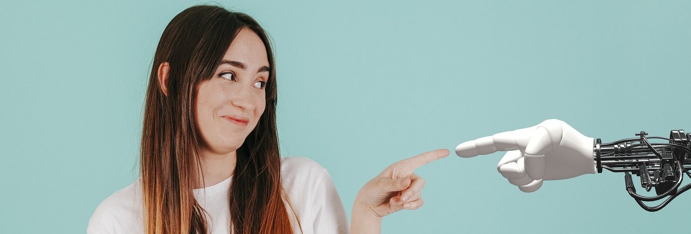 Woman and robot pointing at each other.